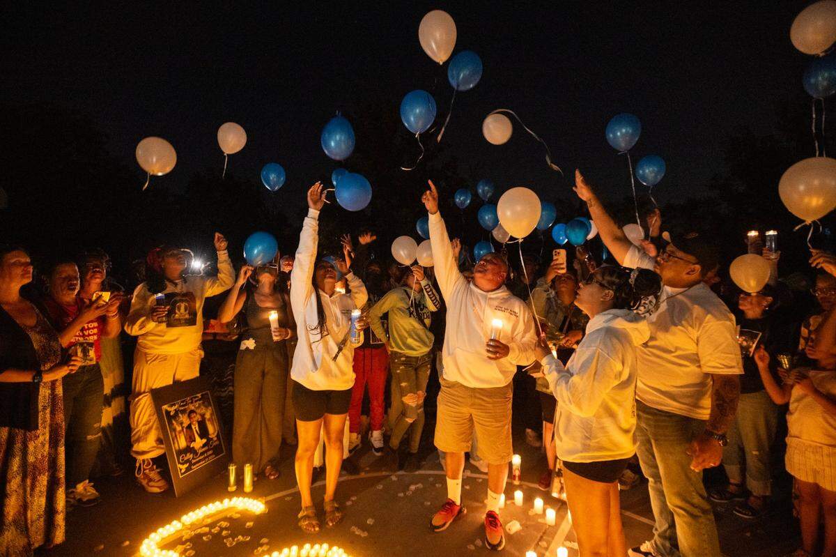 Family members and friends release balloons to remember Colby Tevis during a vigil at Burberry Community Park in Sacramento on Monday evening. He was killed and another hospitalized after a shooting early Saturday morning on J Street in midtown.