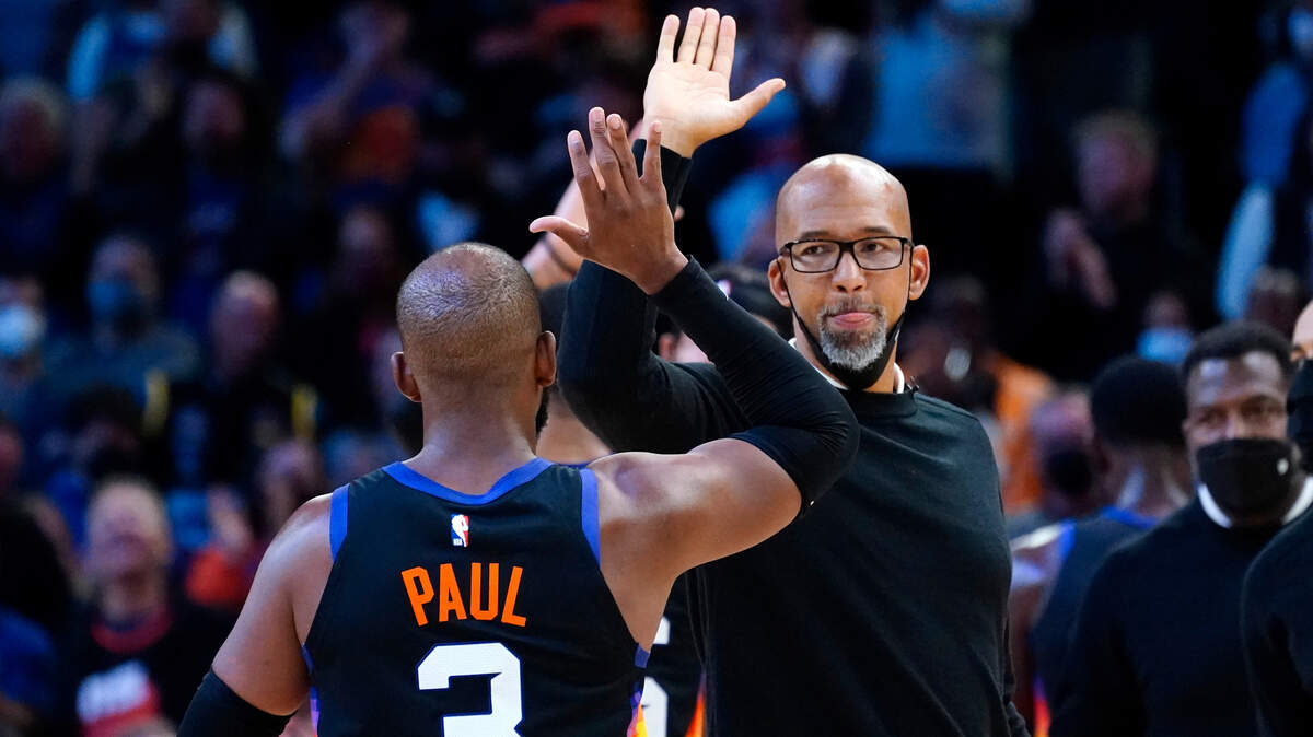 Phoenix Suns guard Chris Paul (3) high fives head coach Monty Williams during the second half of an NBA basketball game against the Golden State Warriors, Tuesday, Nov. 30, 2021, in Phoenix. The Suns won 104-96. (AP Photo/Matt York)