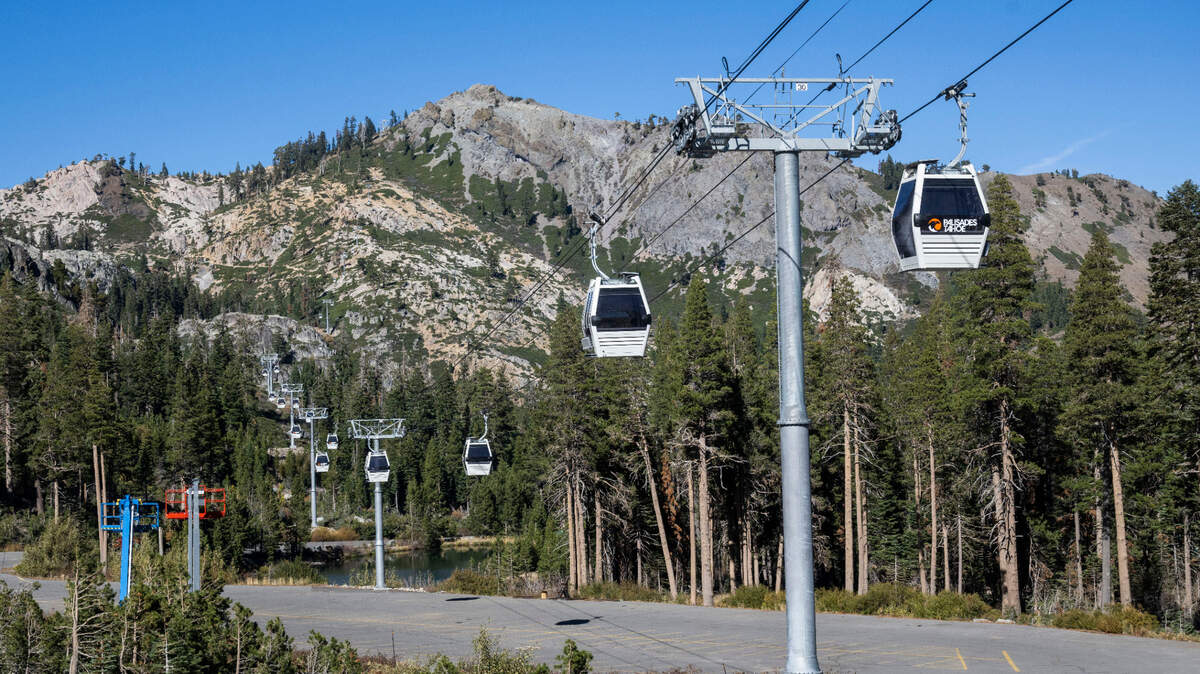 Cabins traverse the Base to Base Gondola route from Alpine Lodge during construction on Thursday, Oct. 27, 2022. A 16-minute trip will take skiers and snowboarders to the Olympic Valley side of Palisades Tahoe, travel previously done by car or bus.