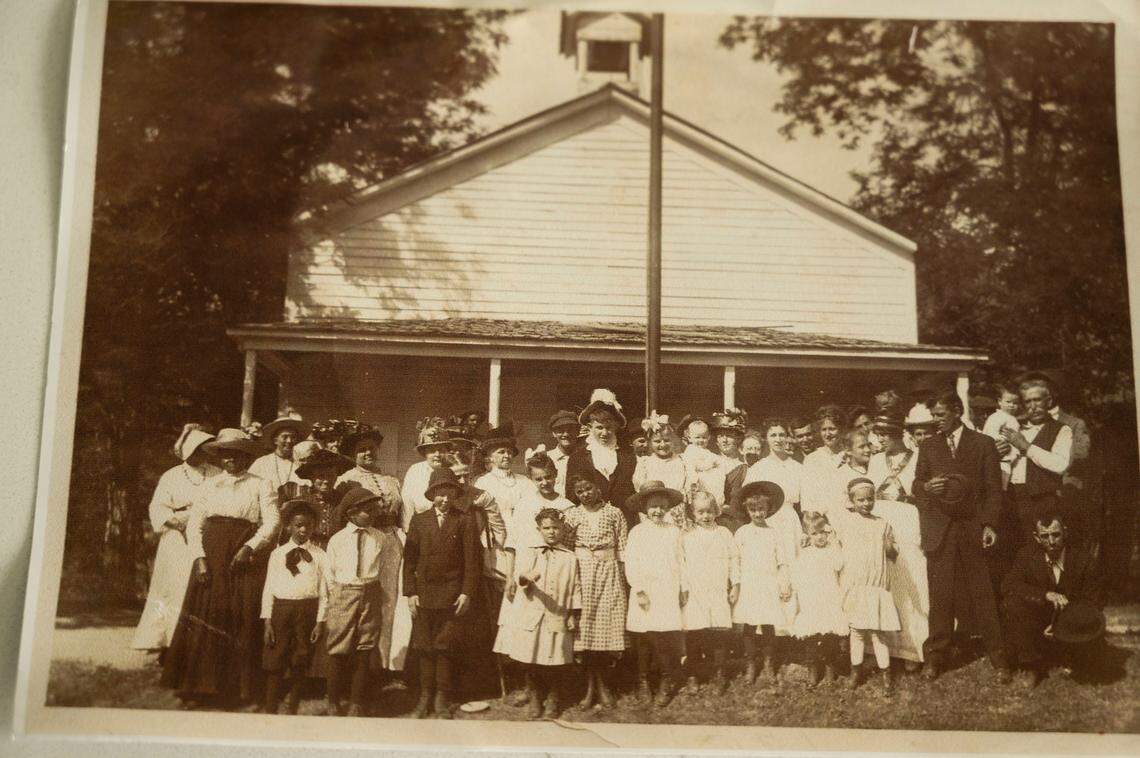 Jonathan Burgess shows a photo of some of his ancestors standing in front of a school in Coloma. His great-grandfather, a former slave called Nellson Bell but known to him as Rufus Burgess, became a successful entrepreneur during the California Gold Rush.