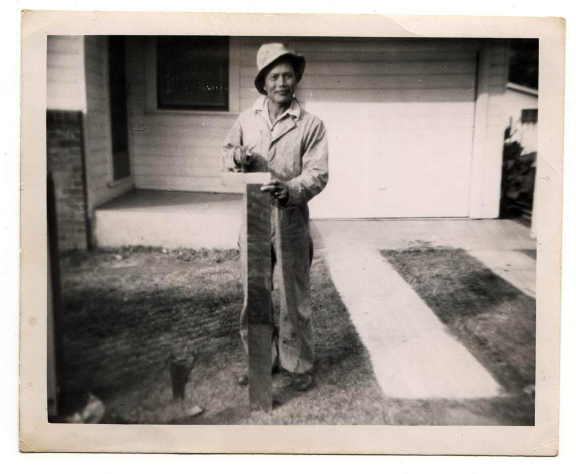 Bonifacio Ulatan builds a fence at his home at 630 3rd Street in West Sacramento that is now the Tree House Cafe.