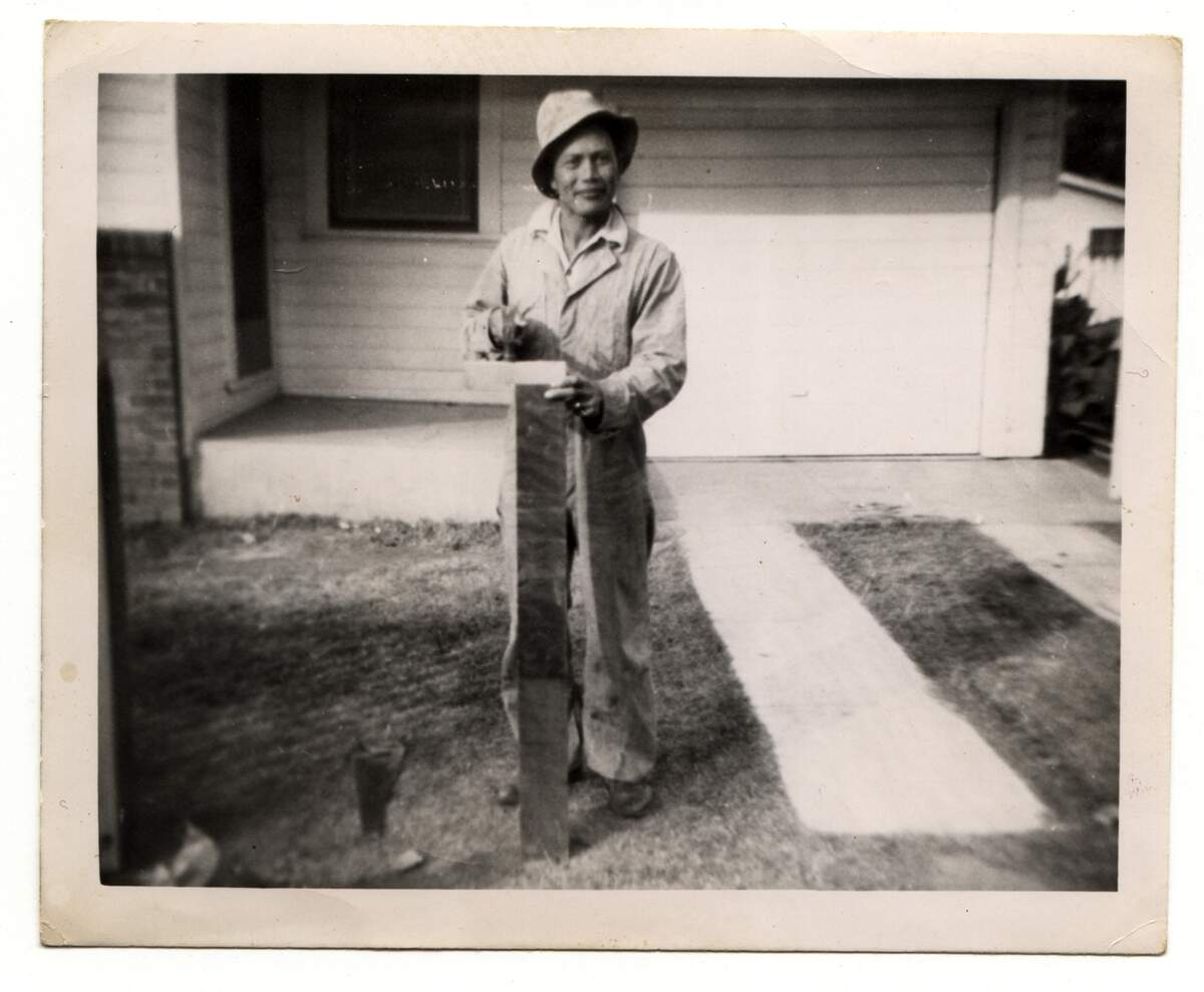 Bonifacio Ulatan builds a fence at his home at 630 3rd Street in West Sacramento that is now the Tree House Cafe.