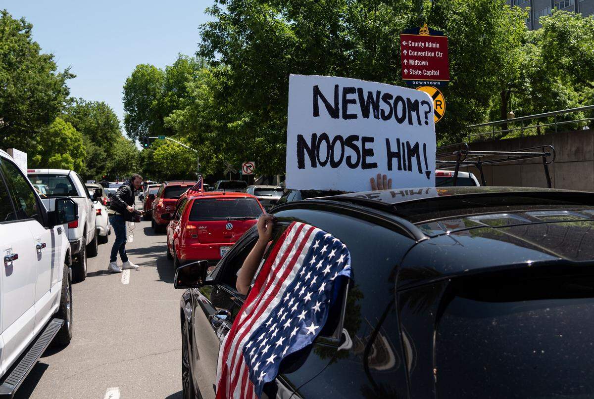 Drivers circle the Capitol to protest Gov. Gavins Newsoms stay-at-home order in Sacramento on Friday, May 1, 2020.