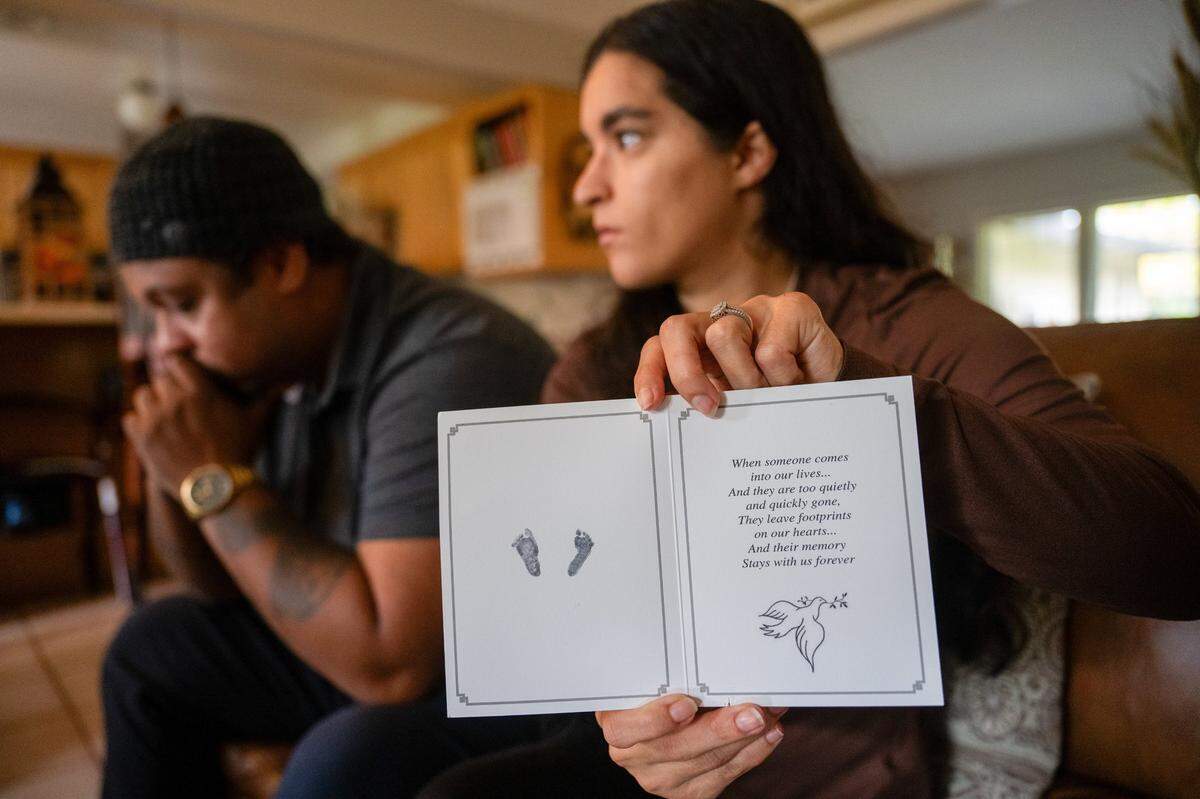 Rachel Harrison, 29, shows last month the card stamped with her baby’s tiny footprints that she received from Kaiser Permanente Sacramento after the hospital performed a procedure to remove the fetus after a miscarriage. The memento would not exist if she had waited for the miscarriage to complete at home, which was what Mercy San Juan Medical Center advised her to do.