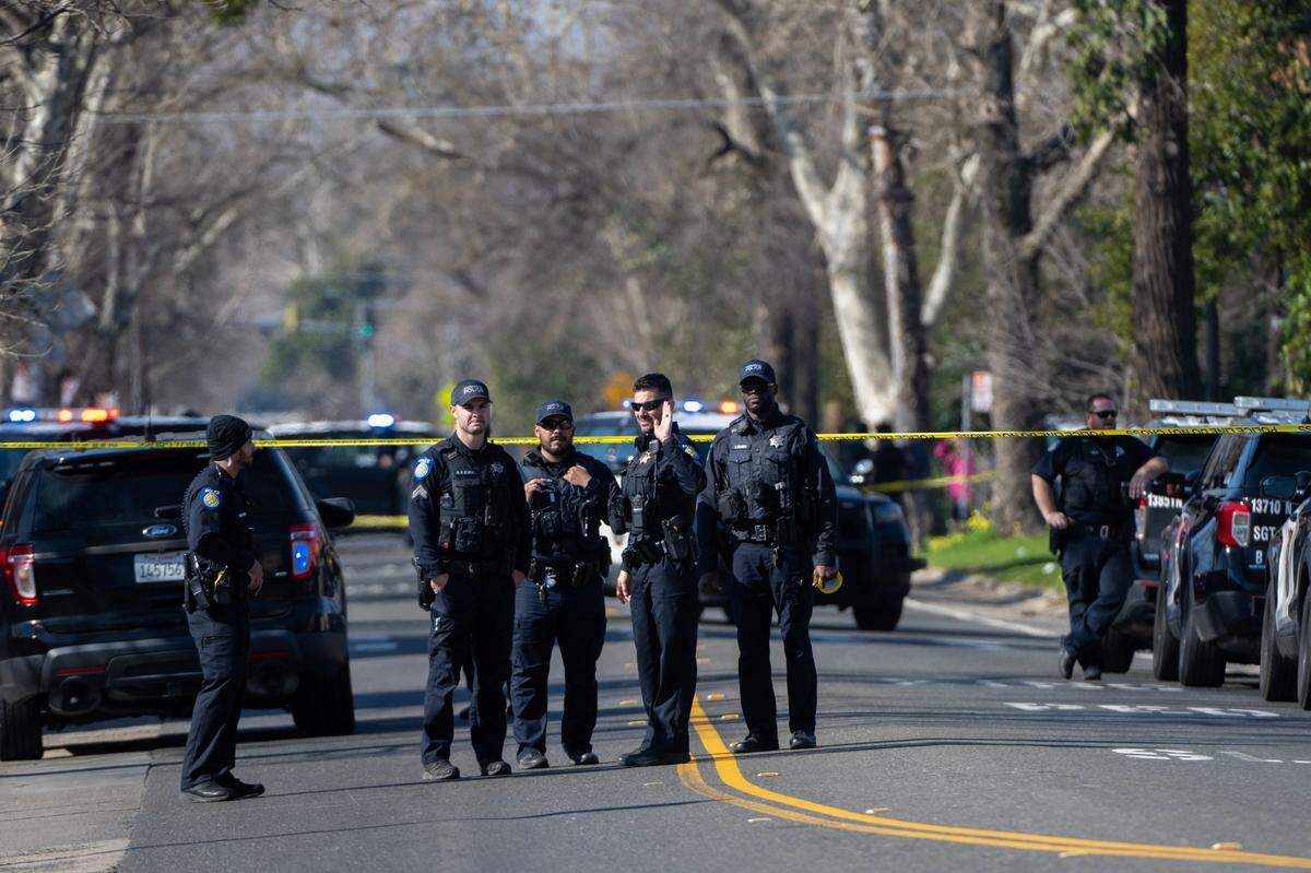 Sacramento Police officers investigate a shooting on Cantalier Street and El Camino Avenue in North Sacramento on Thursday.