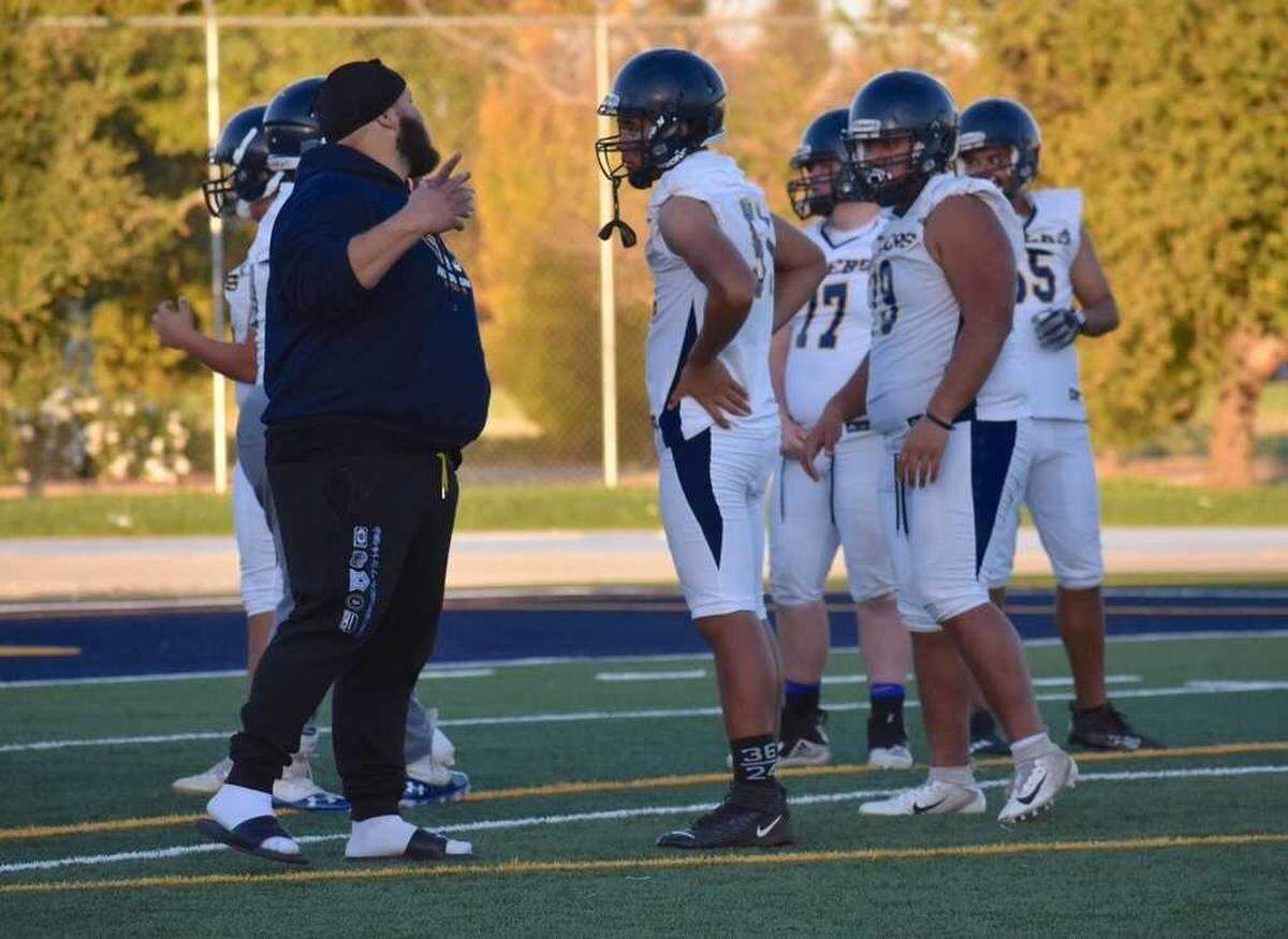 Greg Najee Grimes, left, works with Inderkum High School football players in 2021. Grimes, 31, a former football star at Boise State University who had returned home was shot and killed Monday, July 4, 2022, outside the Mix Downtown nightclub in Sacramento.