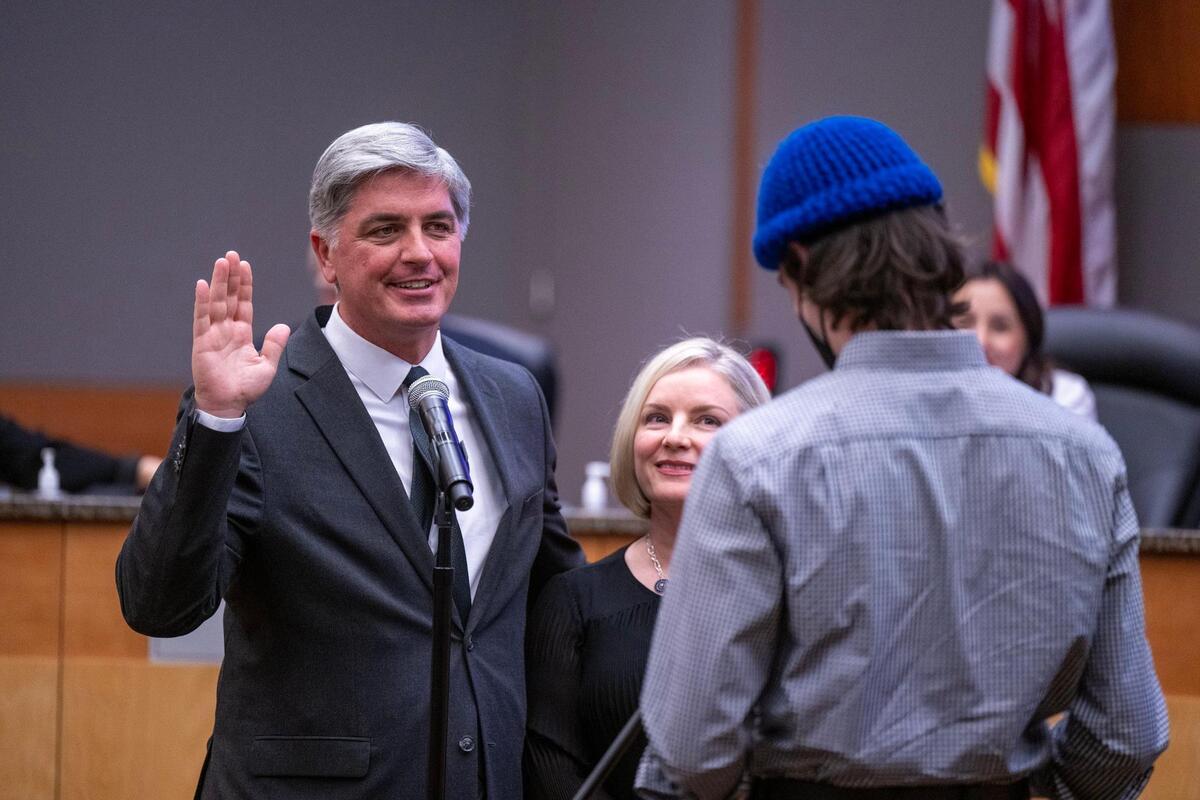 Sacramento City Councilmember Phil Pluckebaum, with his wife Toni by his side, is sworn in at the Sacramento City Council meeting on Tuesday.