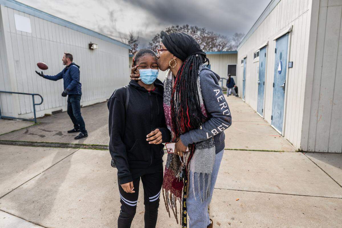 Latrenna Conner kisses her daughter La’anadi Gillett, a student at Ethel I. Baker Elementary School on Thursday. Conner said she’s seen benefits from the school’s integrated Center of Wellness program. The program is designed to help the mental health of students and their family by using a different approach to discipline and teaching.