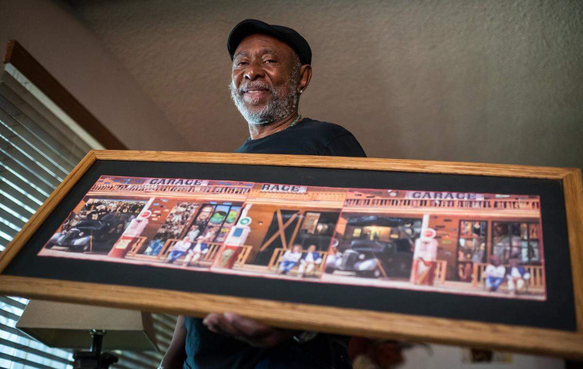 Gary Harrell, an artist who began creating work during his decades behind bars before being released in 2020, holds one of his collages at home in south Sacramento in 2023.