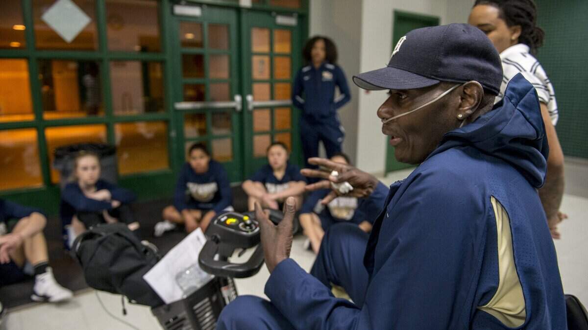 Elk Grove coach Larry Price talks with his team before losing 62-45 to Granite Bay in the Sac-Joaquin Section Division II playoff opener on Feb. 20.