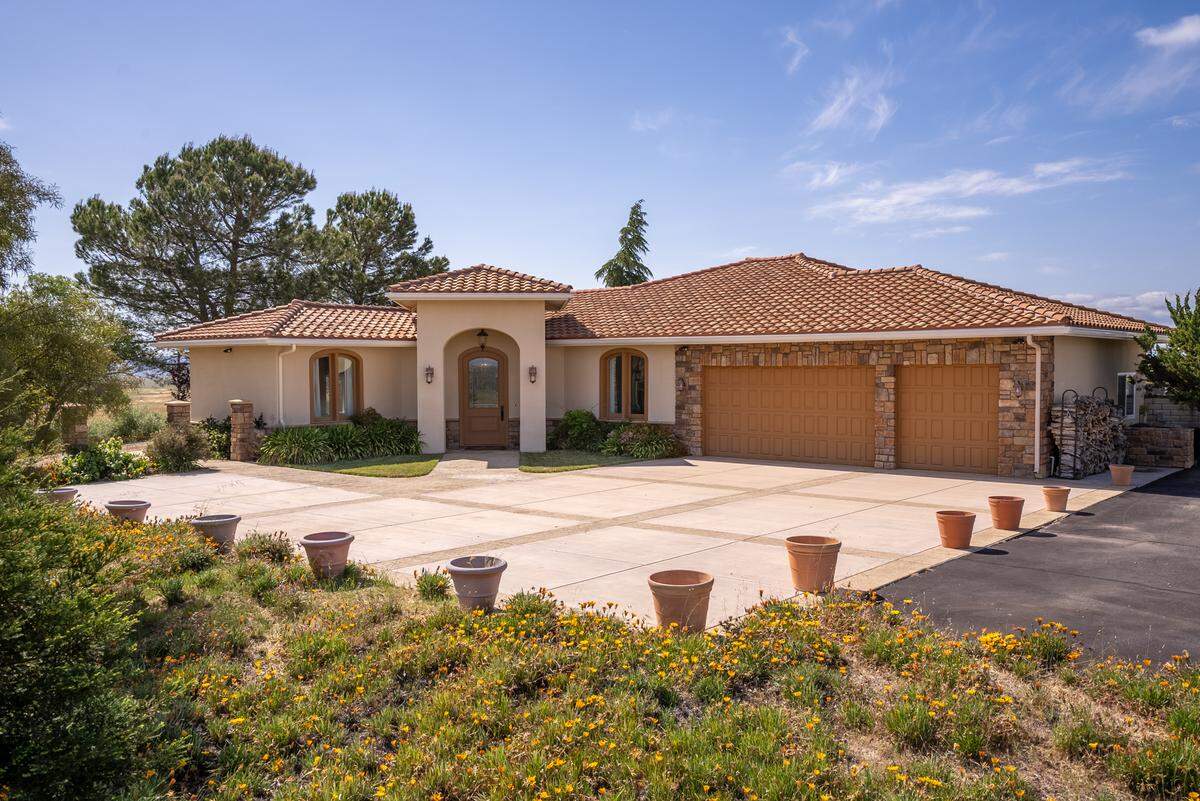 The estate’s main residence, a three-bedroom, three-bathroom house, spans a 2,736 square feet. Outside, there’s an in-ground pool and covered patio and a grand outdoor fireplace.