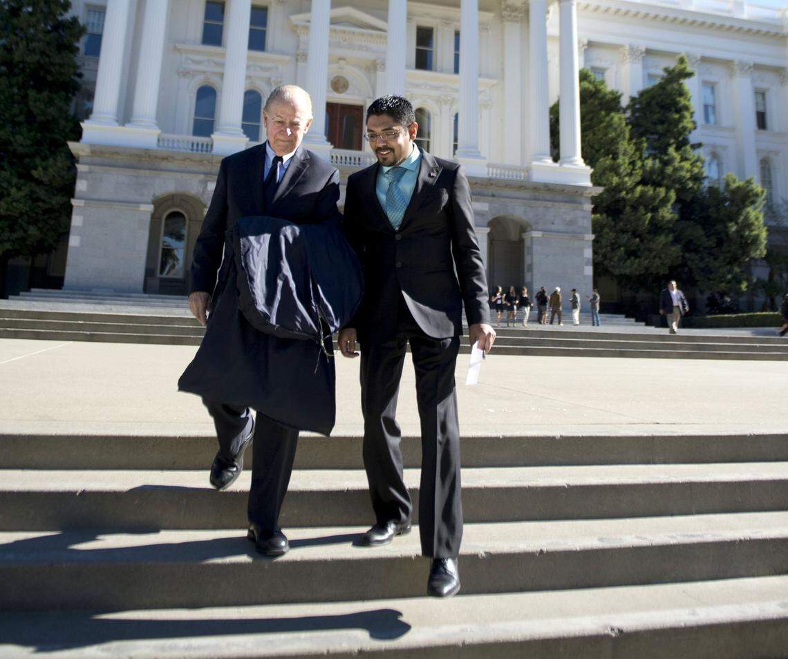 Sergio Garcia, an undocumented immigrant from Mexico, walks with then-state Supreme Court Associate Justice Cruz Reynoso at the state Capitol after being sworn in as an attorney to practice law in California in 2014.