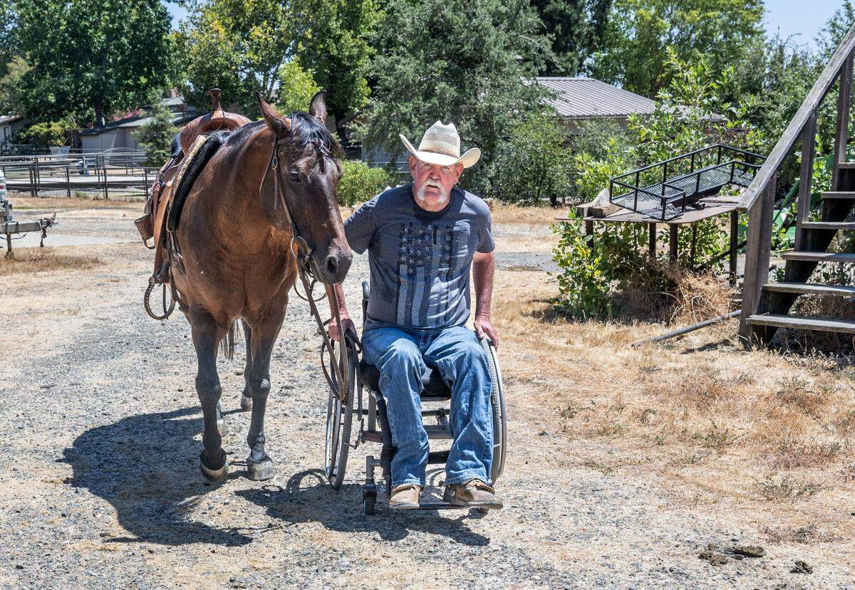 Rick Riedman, of Dry Creek, walks his horse Bella as he maneuvers his wheel chair last month. Riedman suffered an injured by a horse in 2005 but is passionate about living on his four acre ranch in Dry Creek.