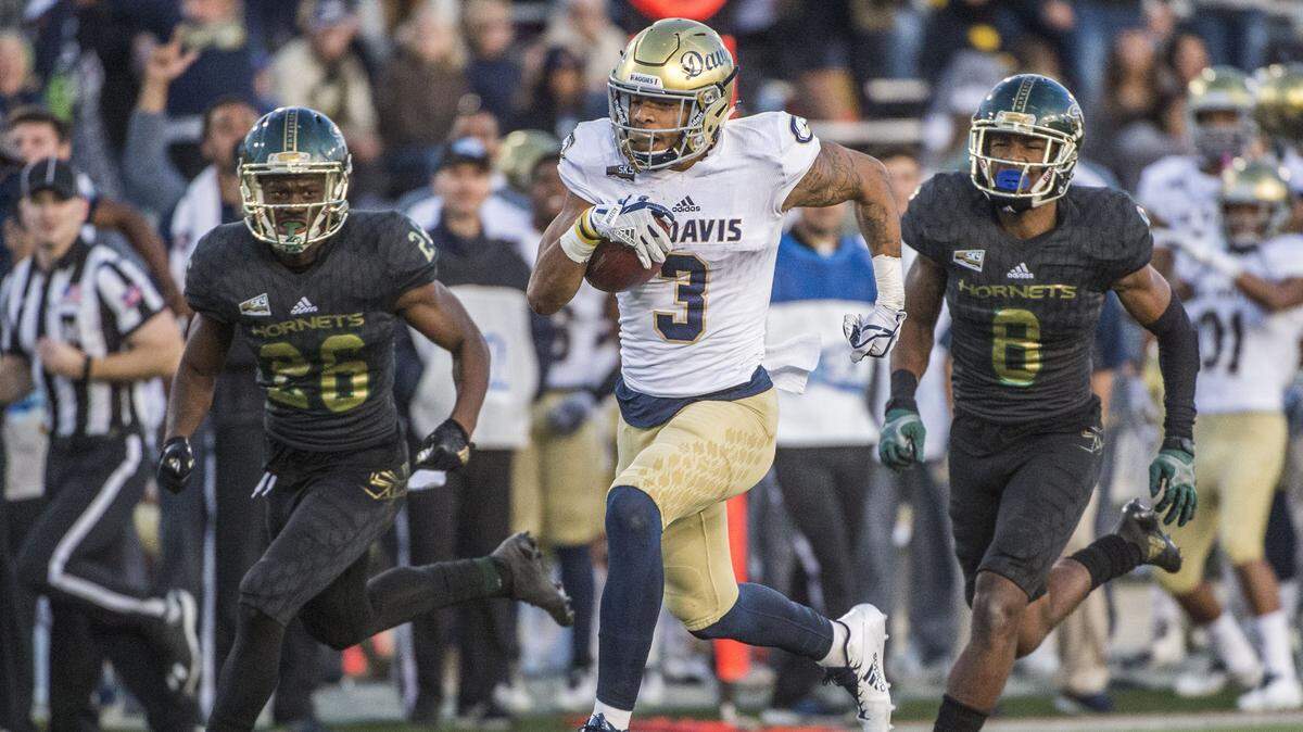 UC Davis receiver Keelan Doss, center, scores a touchdown against Sacramento State in the Causeway Classic on Nov. 18 at Hornet Stadium. Doss on Monday was named the Big Sky Conference’s Preseason Offensive Player of the Year.