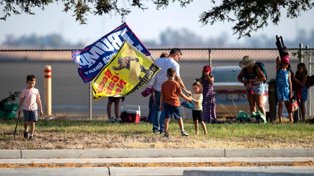 Protesters pack up to leave after President Joe Biden departed Mather Airport in Sacramento on Monday. Biden was in Sacramento to survey the wildfire damag, before heading to Long Beach to campaign with Gov. Gavin Newsom against the recall election.