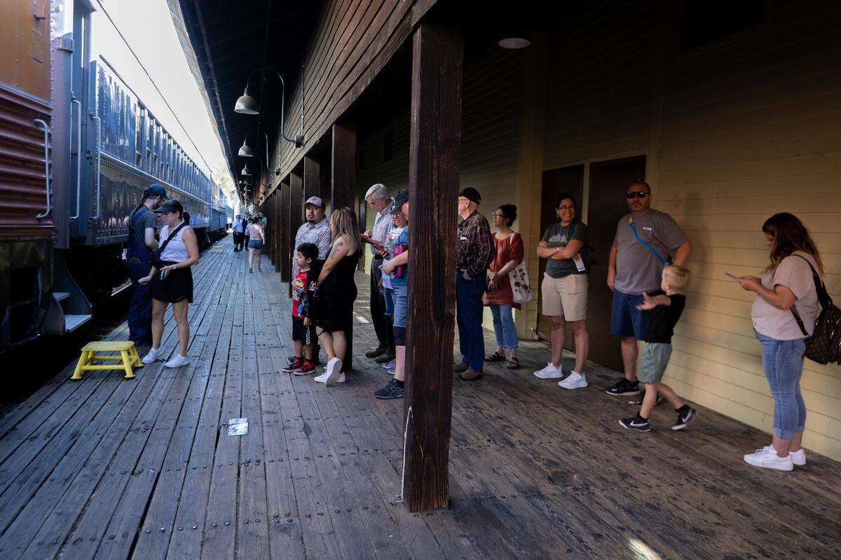 Ticket holders wait to board a passenger car Saturday, Aug. 9, 2025, in Old Sacramento as the California State Railroad Museum’s historic Granite Rock 10 steam locomotive returned to service.
