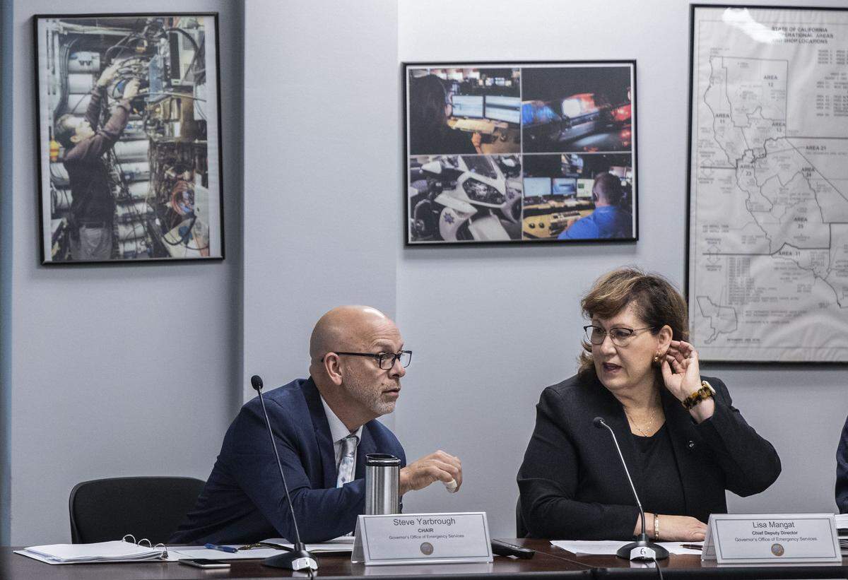 Steven Yarbrough, chair of the State 911 Advisory board, speaks with Cal OES Chief Deputy Director of Policy and Administration Lisa Mangat during a board meeting on Wednesday, Nov. 19, 2025 in Sacramento.