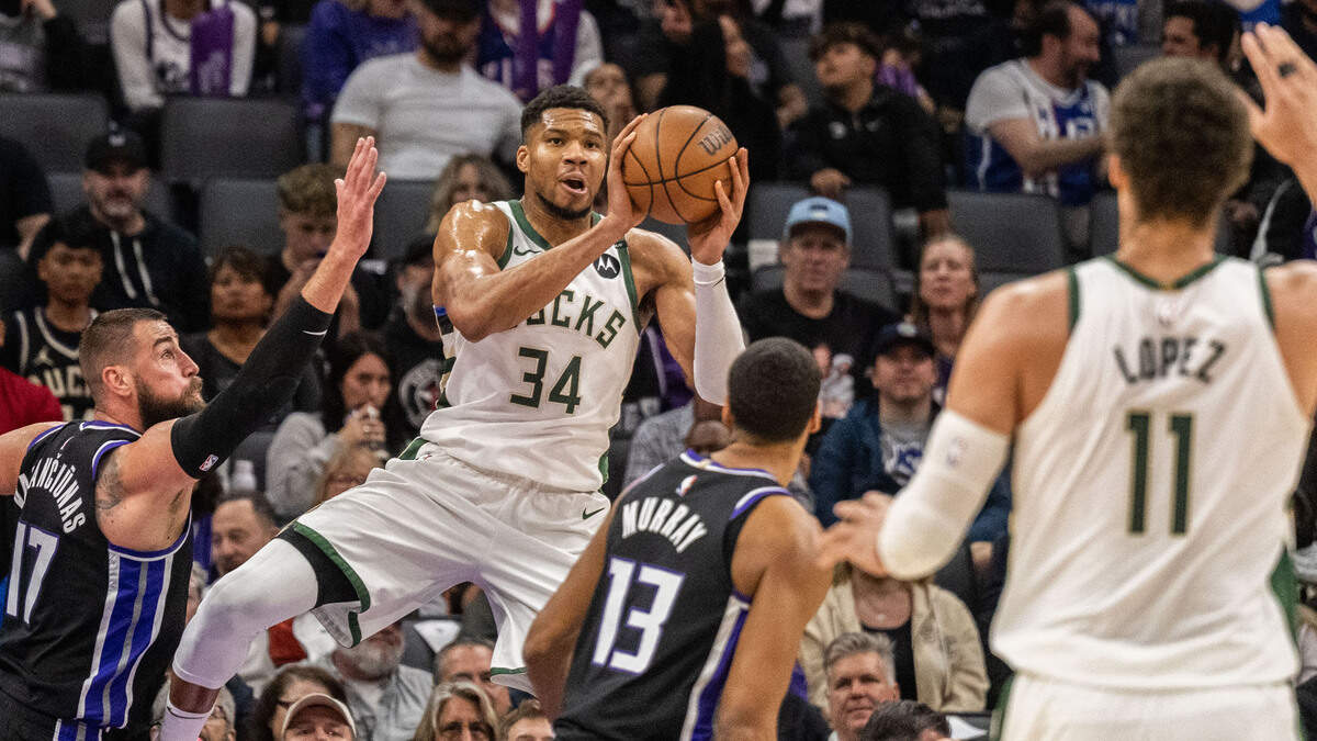 Milwaukee Bucks forward Giannis Antetokounmpo (34) looks to make a pass to center Brook Lopez (11) against the Sacramento Kings on Saturday at Golden 1 Center.