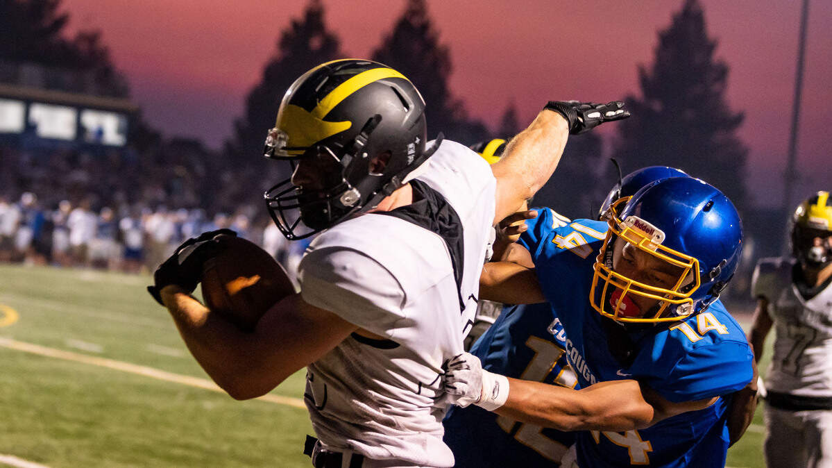 Del Campo’s Stan Chambers, right, prevents a touchdown on a big kick return by Del Oro’s Sam Murray, left, during the second quarter of the high school football game under a smoke-filled sky, Friday, Aug. 27, 2021, at Del Campo High School in Fair Oaks.