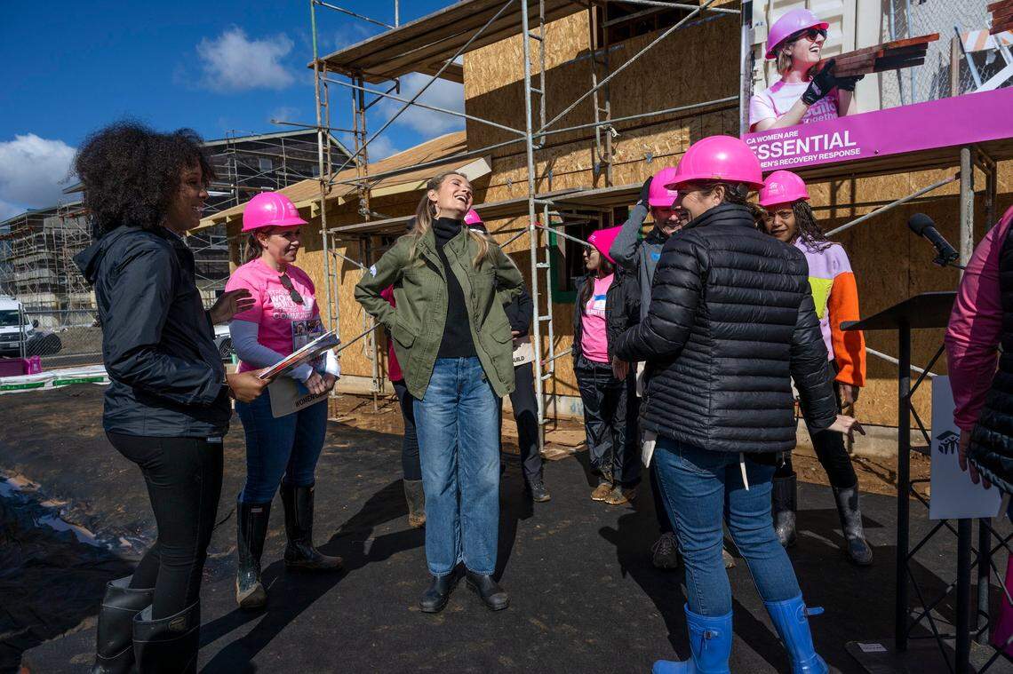 First Partner Jennifer Siebel Newsom shares a laugh with other women during a Habitat for Humanity event to celebrate International Women’s Day in Sacramento on Wednesday.