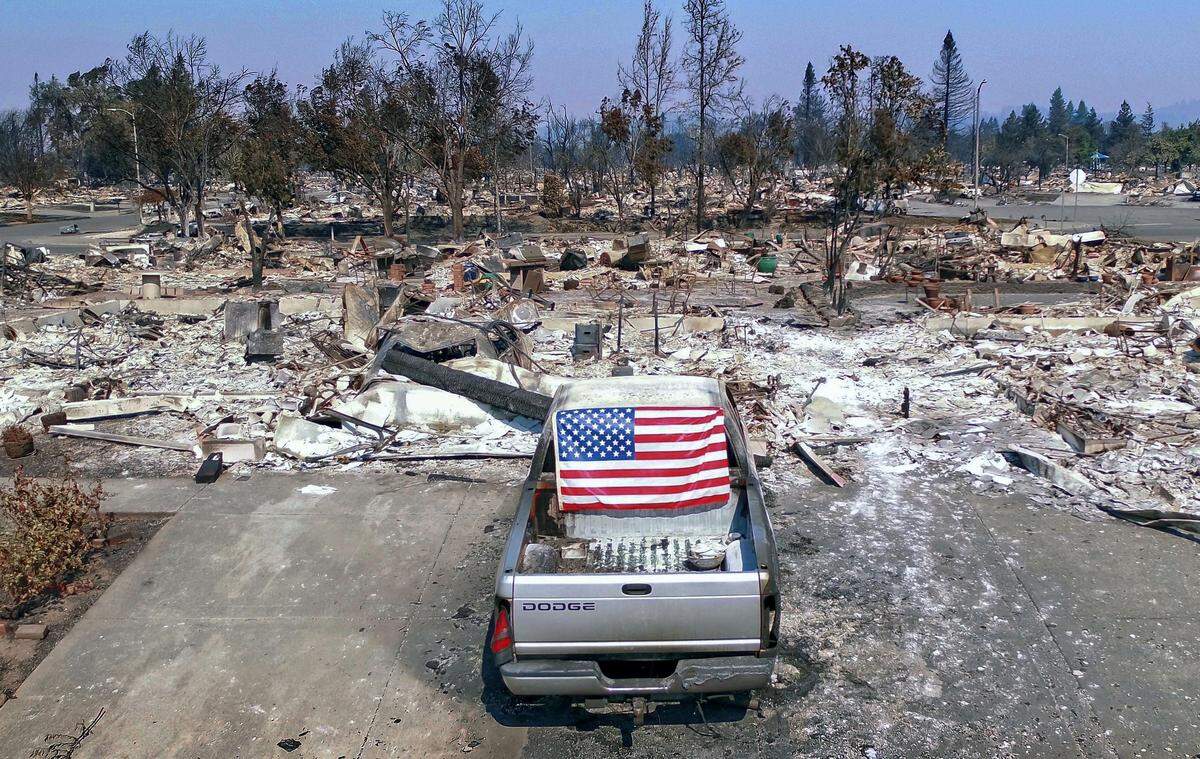 A truck displays an American flag on it’s rear window in the devastated Coffey Park neighborhood on Thursday, October 12, 2017 in Santa Rosa, Calif.