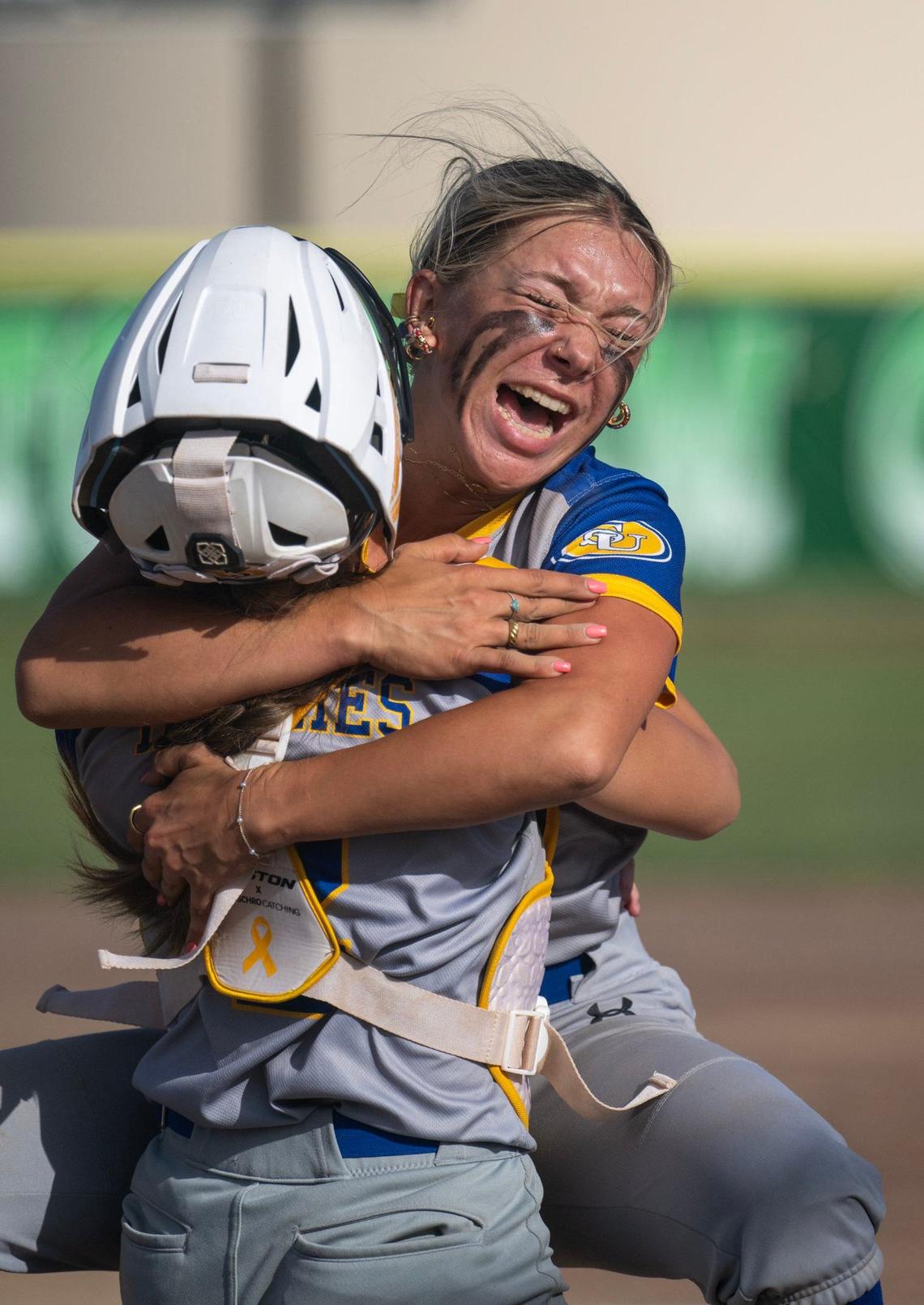 Sutter Huskies pitcher Olivia Bauer (5) embraces catcher Morgan Heggstrom (4) after the final out in the seventh inning against the Dixon Rams for the CIF Northern California softball championship on Saturday, June 1, 2024, at Dixon High School.