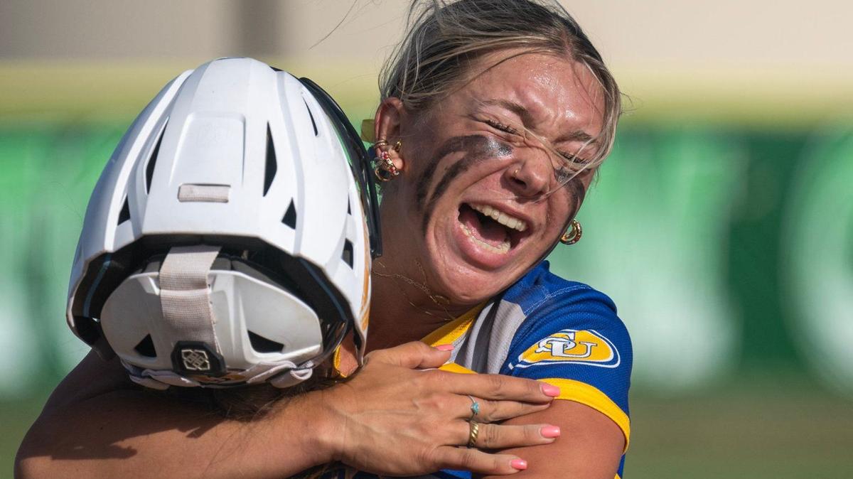 Sutter Huskies pitcher Olivia Bauer (5) embraces catcher Morgan Heggstrom (4) after the final out against the Dixon Rams in the CIF Northern California regional Division III softball championship game Saturday at Dixon High School.
