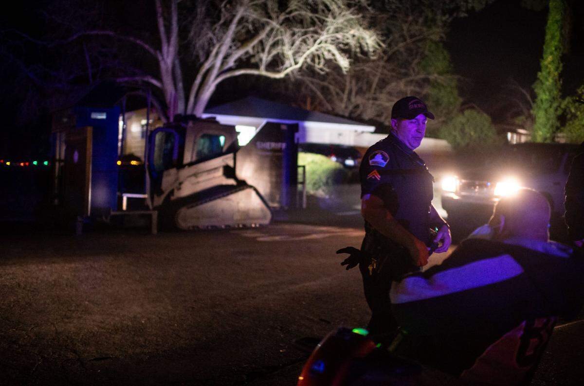 Sacramento County Sheriff’s Deputy Shropshire talks with onlookers after unloading the department’s Rook, an armored Caterpillar vehicle modified to provide protection for SWAT and other police units, after an officer shooting in Carmichael in 2021. Sheriff’s officials said one suspect was fatally shot and another taken into custody. The sheriff’s deputy who was shot was hospitalized.