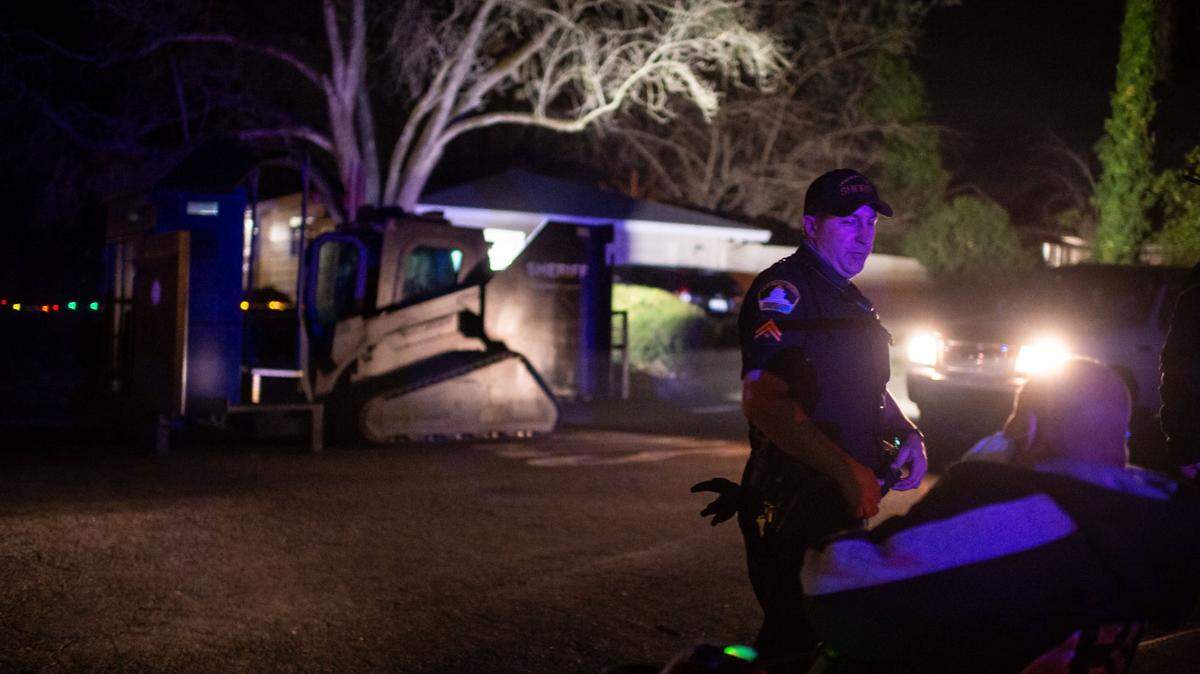 Sacramento County Sheriff’s Deputy Shropshire talks with onlookers after unloading the department’s Rook, an armored Caterpillar vehicle modified to provide protection for SWAT and other police units.