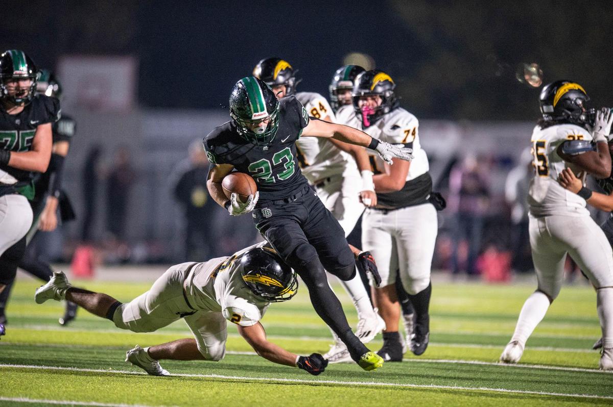 The Twelve Bridges Raging Rhinos’ Braeden Ward (23) picks up a few yards before he is brought down by the Wilcox Chargers’ Brayden Rosa (2) in the third quarter of the CIF Northern California Division 2-A championship game on Saturday.