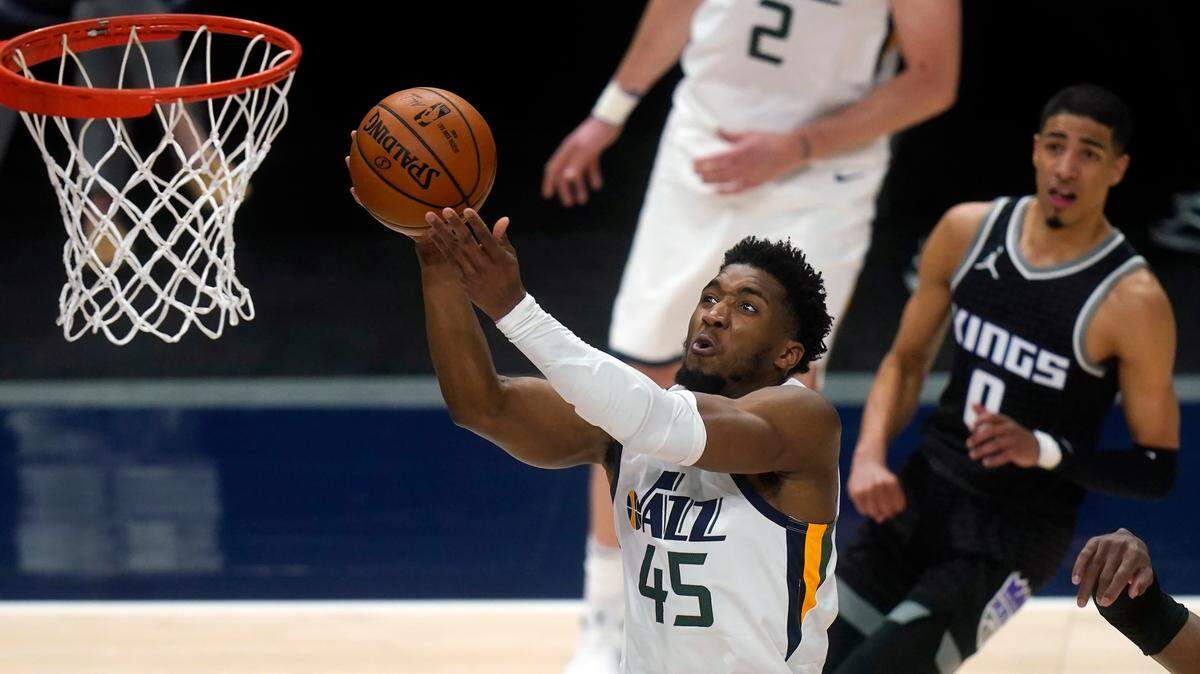 Utah Jazz guard Donovan Mitchell (45) goes to the basket as Sacramento Kings guard Tyrese Haliburton (0) looks on in the second half during an NBA basketball game Saturday, April 10, 2021, in Salt Lake City. (AP Photo/Rick Bowmer)