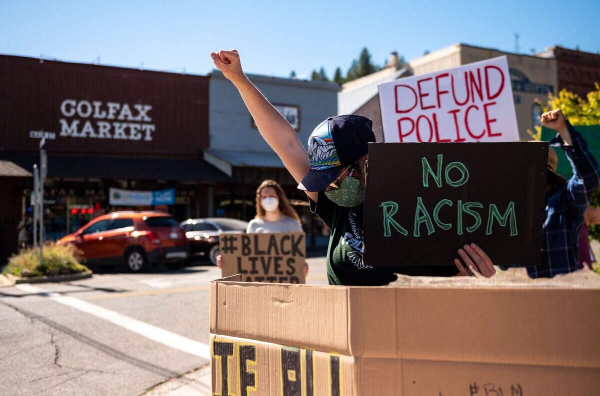 A Placer County resident who did not want to be identified watches her children as she joins demonstrators to rally against racial injustice on Wednesday.