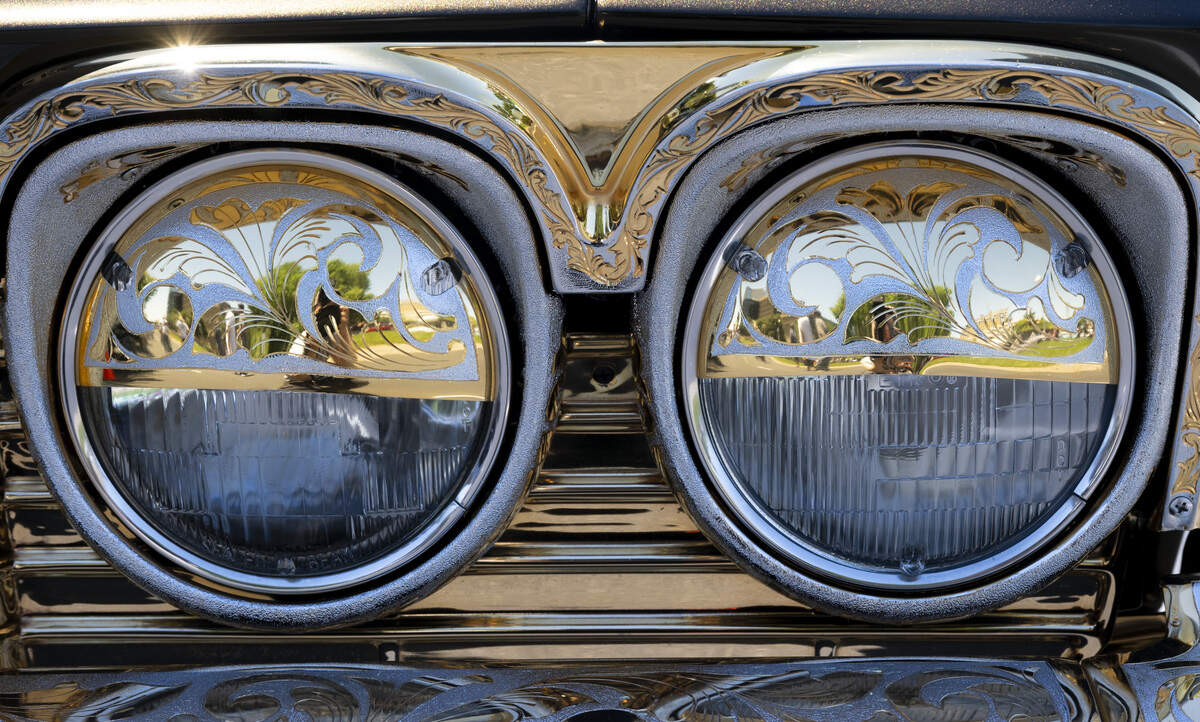 Gold detailing adorns the headlights on Edgardo Garcia’s 1965 Chevy Impala during the fourth annual Lowrider Holiday Celebration in Sacramento on Sunday, June 21, 2026. Garcia has owned the car for over 30 years.
