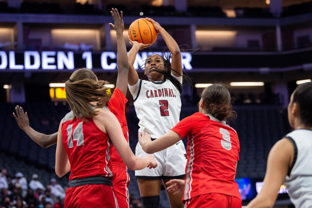 Laguna Creek Cardinals Ahhray Young (2) shoots over Antelope Titans Mary Carter (14) and Gianna Darté (3) during the Division II sectional finals at the Golden 1 Center on Friday, Feb. 25, 2022 in Sacramento.