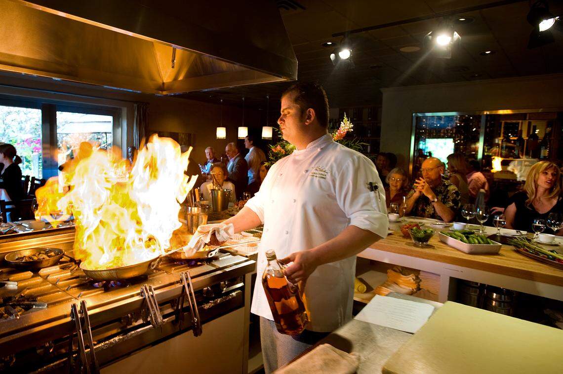 Then-chef de cuisine Noah Zonca prepares food while customers watch during a meal show at The Kitchen in 2008. Zonca died in 2018. His son said he struggled with depression and addiction before his drowning death.