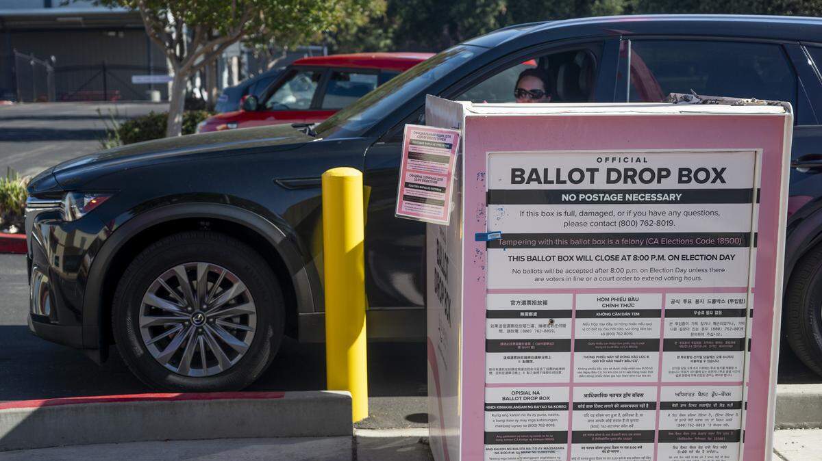 A woman in her car drops off her ballot at the ballot drop box in front of the Sacramento County Voter Registration and Elections building in Sacramento on Tuesday, June 2, 2026.