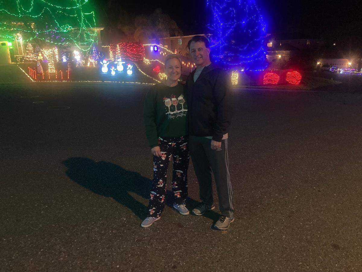 Jodi and Brian Escamilla pictured Dec. 4, 2024, on Darvel Court in Folsom, where they and their neighbors have decorated for Christmas for 23 years.
