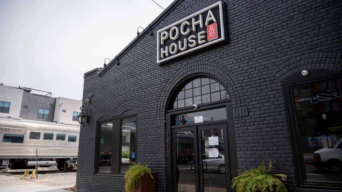 A train goes past Pocha House on Tuesday, June 6, 2023, a new Korean pub and restaiurant that recently opened in Midtown on Q Street.