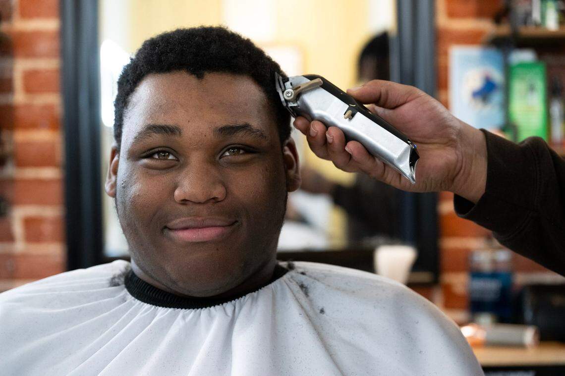 Grant High School student Amiere Lewis has his hair trimmed at HAIRitage Salon last month where the barbers are trained to be mental health advocates for Black men, boys and their families.