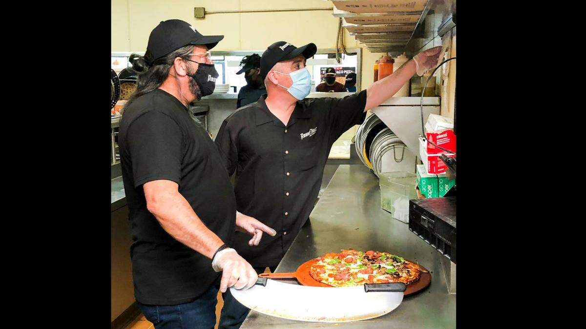 Then-Round Table Pizza CEO Paul Damico, left, and Elk Grove general manager Steve Trillas on an upcoming episode of the CBS show “Undercover Boss.”