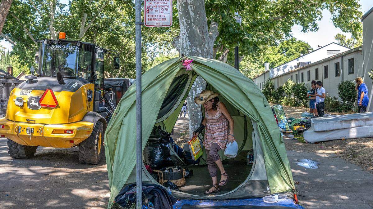 Alicia Peterson, 55, who had just gotten out of the hospital four days ago and suffered neuropathy and a broken wrist, was one of the last to pack up her belongings during a homeless encampment sweep along C street between 27th and 28th streets in Sacramento on Wednesday, July 19, 2023. She was hoping to keep her tent and was unsure where she might go.