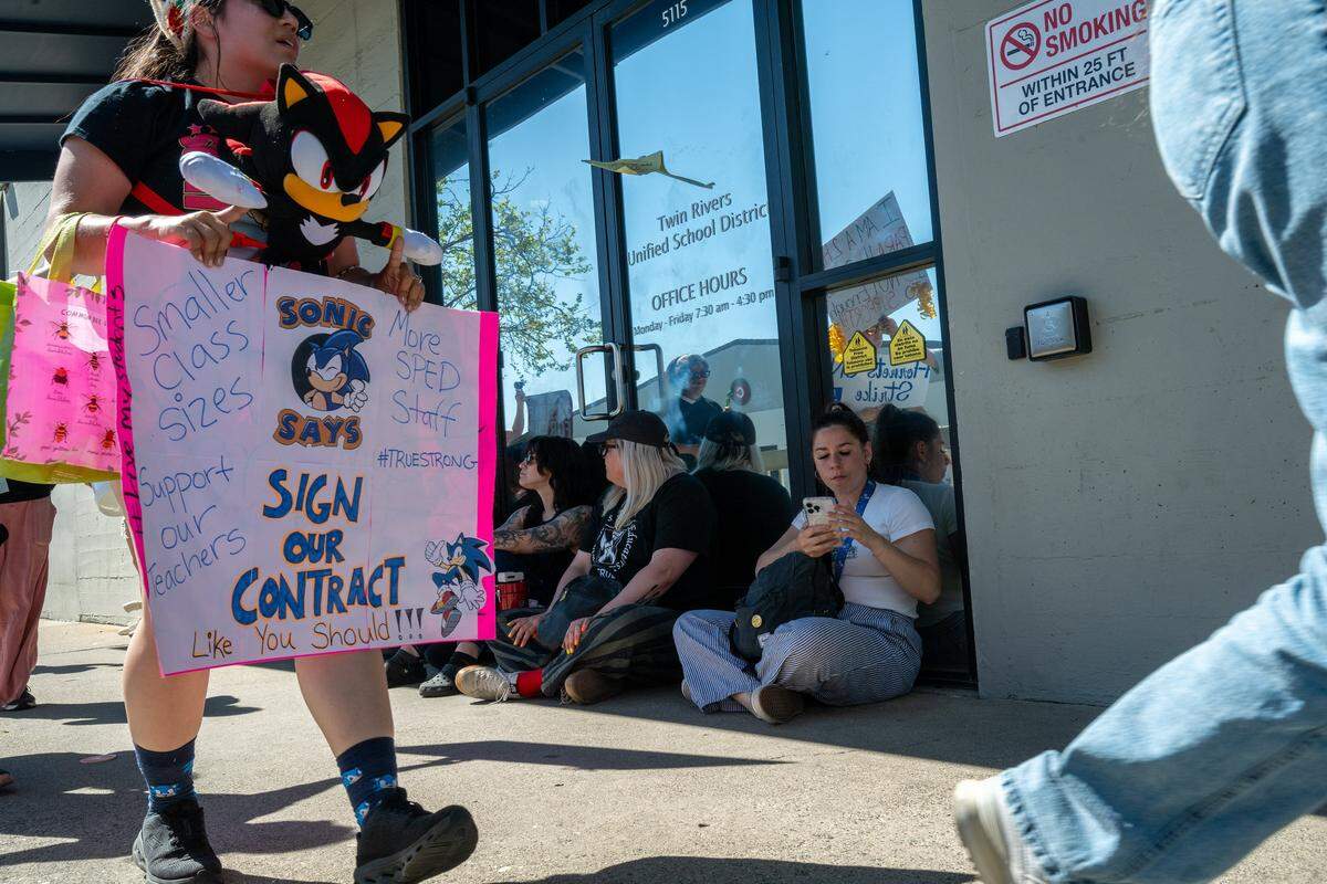 More than 1,000 teachers and parents rally at the Twin Rivers Unified School District office at McClellan Park on Friday, staging a sit-in and demanding that the district return to the table.