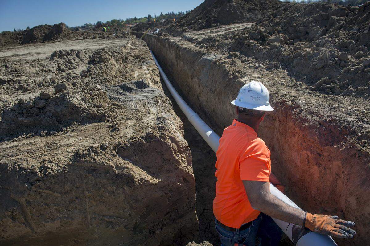 A construction worker installs electrical conduit at The Cannery housing development in Davis in 2015. Completed more than a decade ago, The Cannery is the city’s last major residential project and sits next to the proposed Village Farms site, which supporters say could help bring back the “missing generation” of families priced out of Davis.