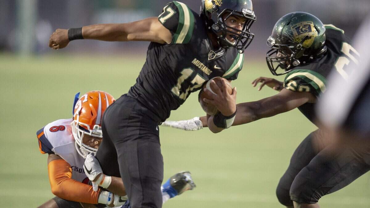 Monterey Trail Mustangs Zach Larrier (17) passed for 171 yards and 3 touchdowns and ran for 163 and another 3 TDs in a 63-28 win over Cosumnes Oaks on Friday, Sept. 7, 2018.