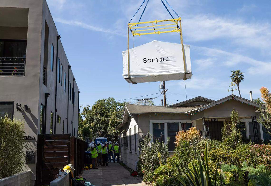 A modular house is lowered into place at a project site in Culver City on March 21, 2025. 