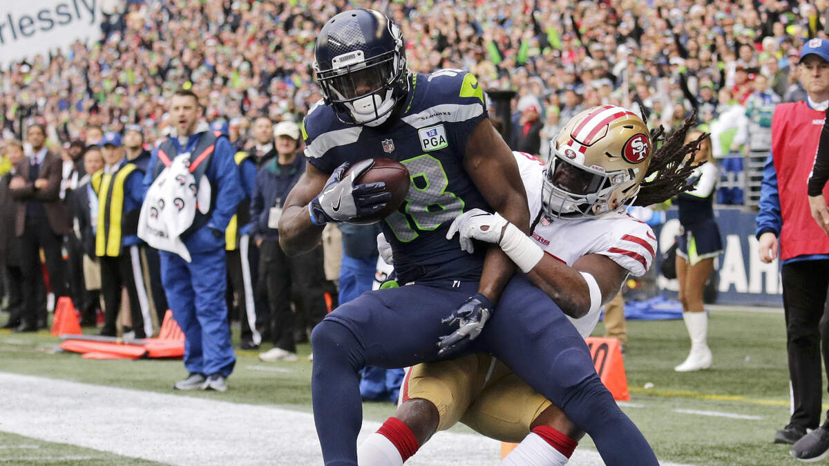 Seattle Seahawks receiver Jaron Brown is tackled by 49ers defensive back Marcell Harris on Dec. 2 in Seattle. Harris made his first NFL start in that game and could start again when the teams meet Sunday at Levi’s Stadium.