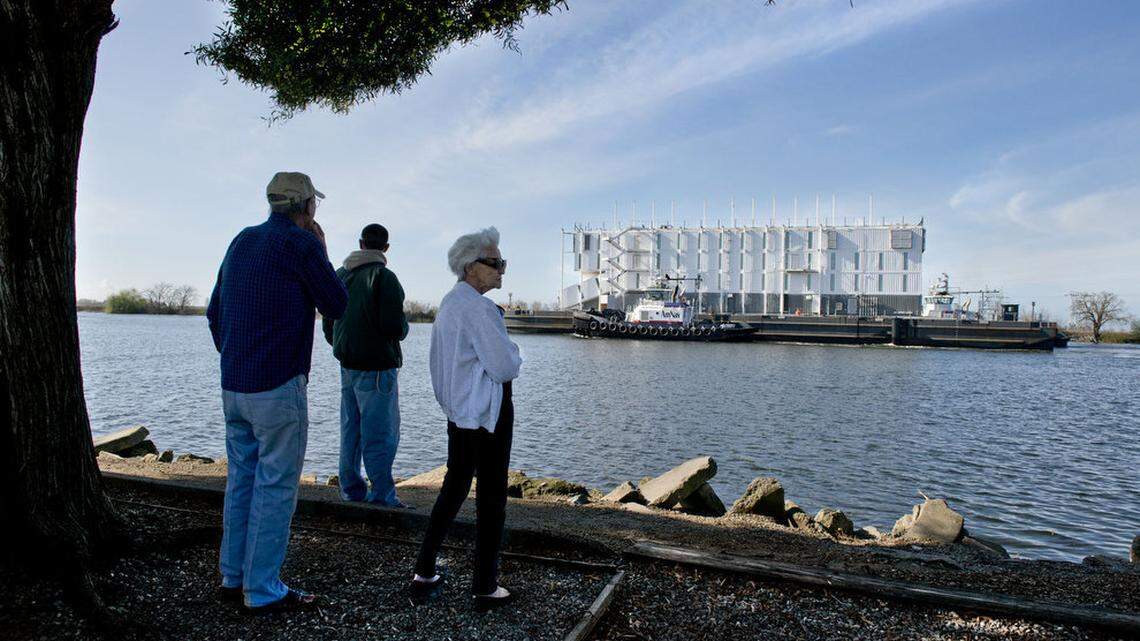 Nathan and Mary Ella Orr along with Andrew Rehberg look on toward a Google barge arriving at the Port of Stockton in 2014.
