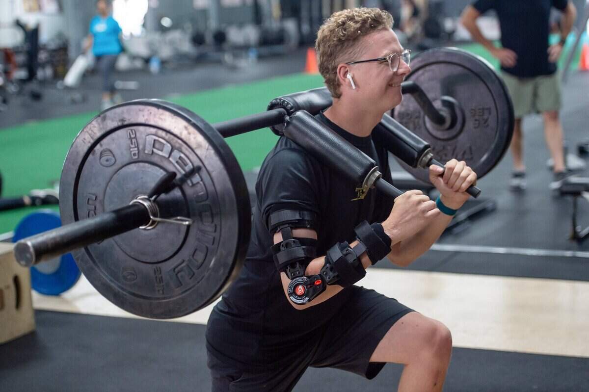 Former Sac State pitcher Stone Churby does rehabilitation exercises at the Academy Training & Performance Center in downtown Sacramento on June 16. Churby’s exercises are coordinated between strength and conditioning coach Bryan Francis and his physical therapist Evan Hauger.