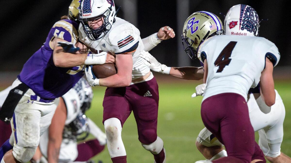 Union Mine running back Scott Smith (1) runs the ball up the middle for a 1-yard gain before being tackled by Bradshaw Christian linebacker Joey Avila (54) during the first quarter in the game at Bradshaw Christian High School on Friday, Oct. 22, 2021. The Diamondbacks won 27-14.