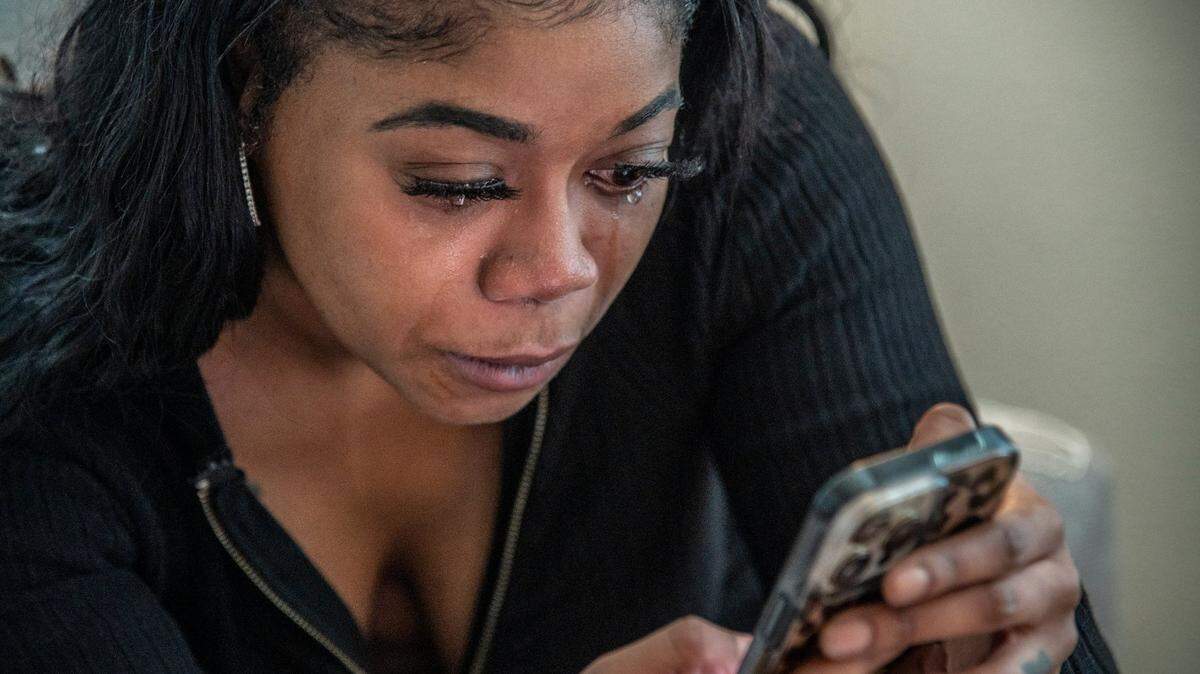 Tears stream down Alexis Holmes’ face as she looks over pictures and videos of her son RJ Holmes on Thursday, March 24, 2022 in West Sacramento. Allexis is suing her ex-husband, Kings forward Richaun Holmes, in separate custody and domestic violence cases. Now, she is seeking a restraining order on behalf of their 6-year-old son, Richaun Jr.  also known as RJ  pertaining to an incident on Feb. 6 when RJ came home from a visitation with his father with a bloody goose egg over his left brow. 
